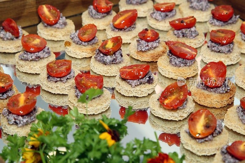 canapé with black olives and tomato confit